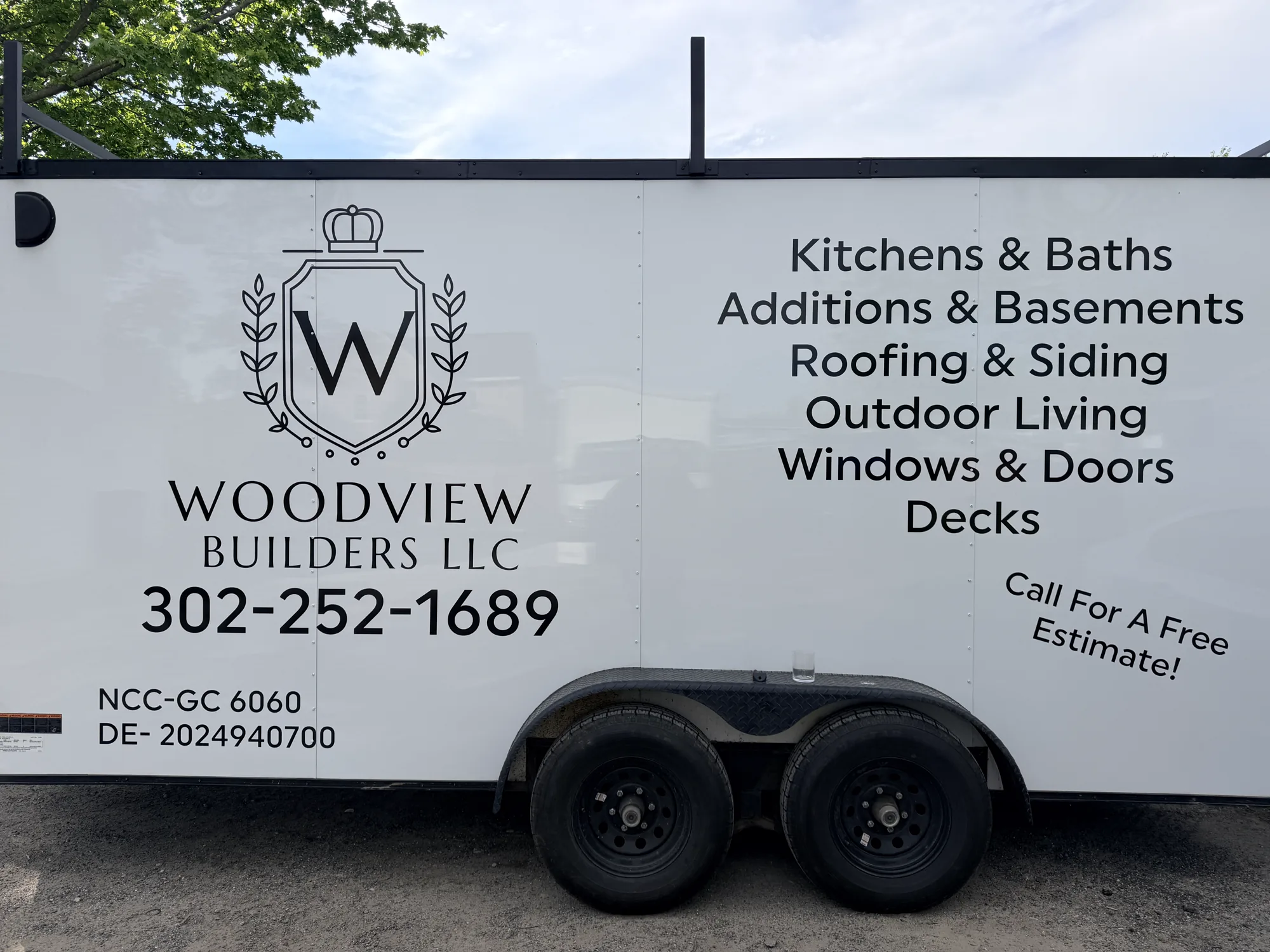 Enclosed work trailer lettering for Woodview Builders in New Castle County, DE — logo, services list, and license numbers in crisp cut vinyl